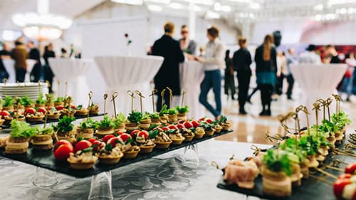 Assorted platters and canapés laid out for a corporate function